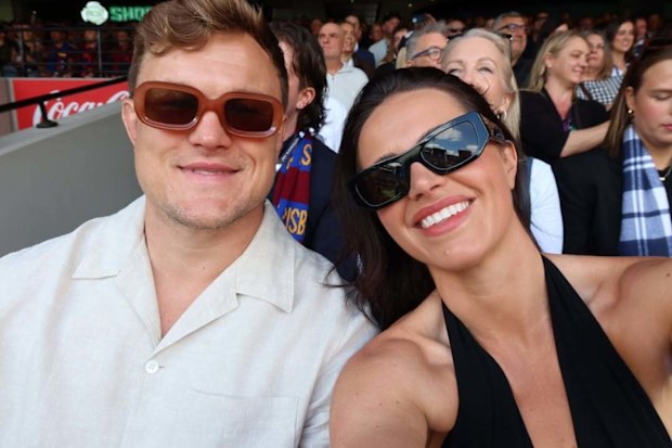 Danika Mason and Liam Knight take a selfie at a sporting event.
