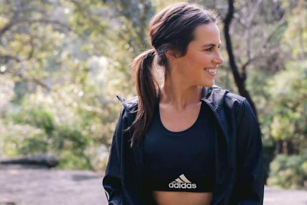 Danika Mason standing outdoors wearing workout clothing.