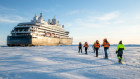 Snowshoeing towards Ponant’s Le Commandant Charcot at Hanusse Bay in Antarctica ensures you get up your exercise quota.