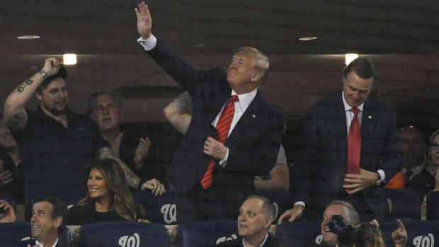 US President Donald Trump waves to the crowd during Game 5 of the World Series between the Washington Nationals and the Houston Astros at Nationals Park in Washington on Sunday.
