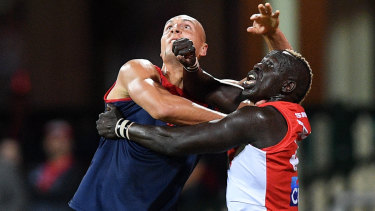 New Demon Braydon Preuss in the contest with Sydney's Aliir Aliir.