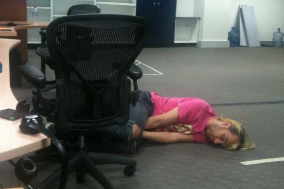 Fred Schebesta sleeping on an office floor.