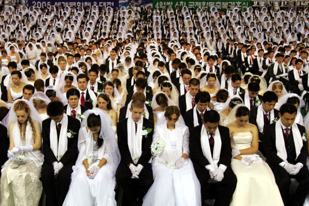 More than 4000 couples get married in a ceremony arranged by the Reverend Sun Myung Moon’s Unification Church in South Korea in 2005.