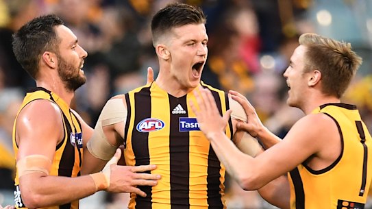 Happy Hawks: James Cousins (centre) celebrates a goal during the round 8 clash against GWS at the MCG.