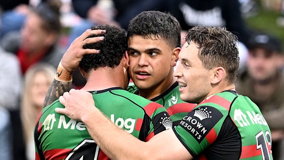 Latrell Mitchell celebrates scoring a try with Rabbitohs teammates.
