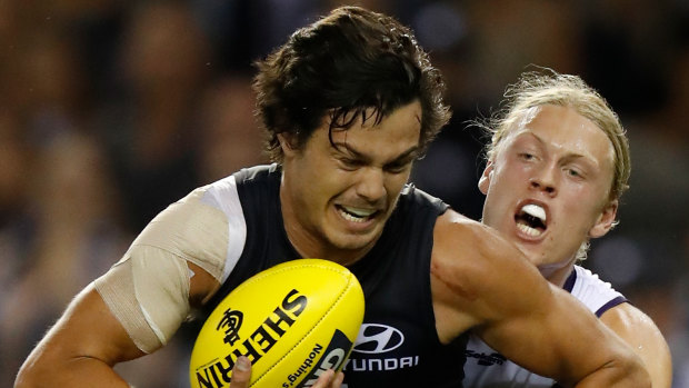 Hayden Young tackles Jack Silvagni in the first half. 