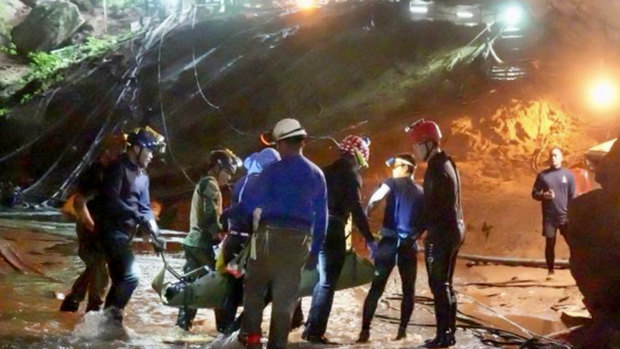 One of the boys is seen being stretchered out of the cave on Tuesday night. 