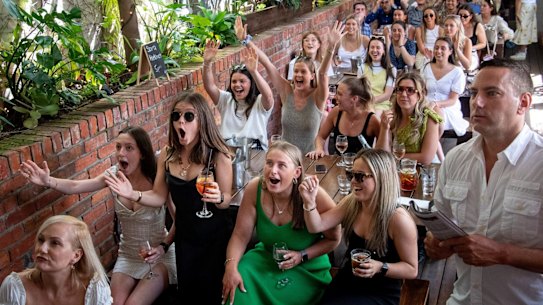 Patrons at the Prince Alfred Hotel in Richmond watches the Melbourne Cup race. 3 November 2020. The Age News. Photo: Eddie JIm. ( Glen Perry and Molly Tobin at the front )