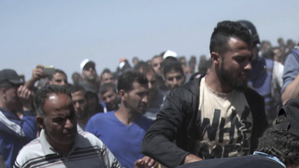 An elderly Palestinian man falls after being shot by Israeli troops at the Gaza Strip's border with Israel last year. Thousands of Palestinians  protested as Israel celebrated the inauguration of a new US embassy in contested Jerusalem. 