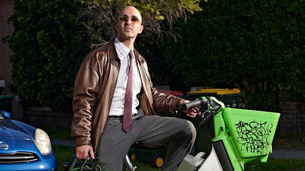 Eugenio Tarantola rides an e-bike to the office in Sydney.