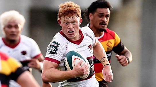 Tane Edmed makes a break for North Harbour against Waikato.