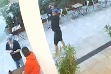 Anthony Godin was struck to the head, allegedly by a man with a golf stick in hand, as he sipped his coffee in Perth’s CBD.