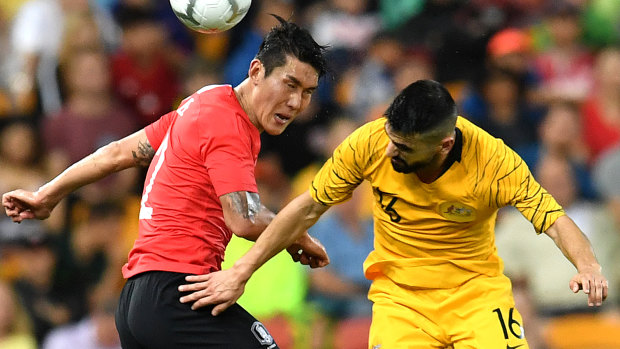 Heads up: Lee Yong of Korea Republic and Aziz Behich compete for the ball in the air.