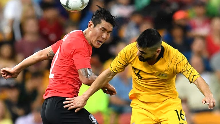 Heads up: Lee Yong of Korea Republic and Aziz Behich compete for the ball in the air.