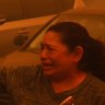 A woman cries as the Palisades Fire advances in the Pacific Palisades.