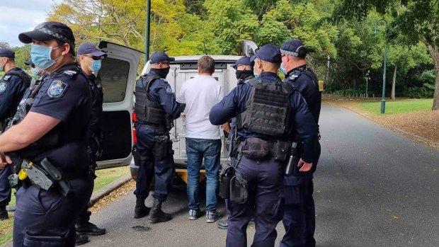 Police arrest one of the demonstrators on Monday.