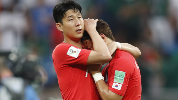 Up against it: Son Heung-min, left, embraces teammates Hwang Hee-chan after their loss to Mexico.