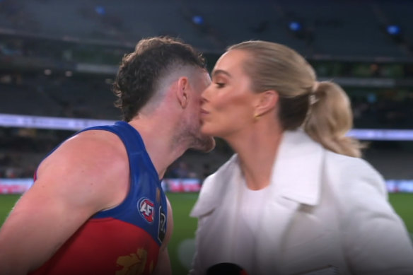 Brisbane player Lachie Neale leans in to give Channel 7 reporter Abbey Holmes a kiss at Marvel Stadium last Friday.
