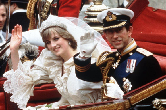 The Princess and Prince of Wales wave from their carriage on their wedding day.
