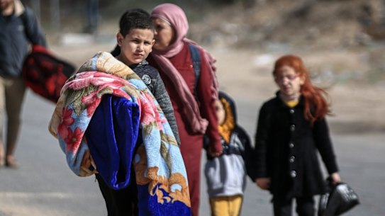 Displaced Palestinians walk along the Salah al-Din road towards the southern Gaza Strip in November. The UN estimates more than 80% of the Gazan population of 2.3 million are displaced.