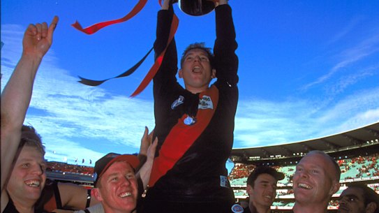 James Hird holds the 2000 premiership cup aloft.