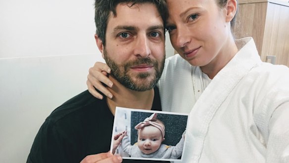 Rachael and Jonathan Casella hold a photograph of their daughter Mackenzie. 