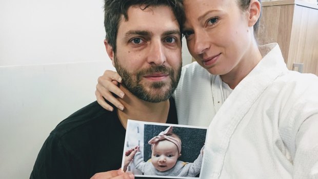 Rachael and Jonathan Casella hold a photograph of their daughter Mackenzie. 