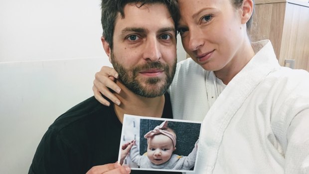 Rachael and Jonathan Casella hold a photograph of their daughter Mackenzie. 