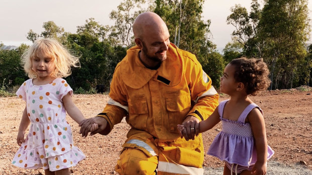 Volunteer firefighter Temil Ludwig is greeted by his daughters after a 27 hour shift near Yeppoon. 