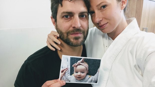 Parents Jonathan and Rachael hold a photo of  their baby daughter Mackenzie, the namesake of the trial. 