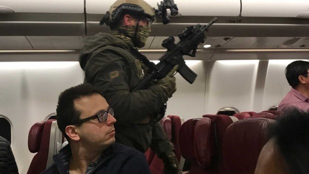Police storm flight MH128 after Manodh Marks tried to enter the cockpit.