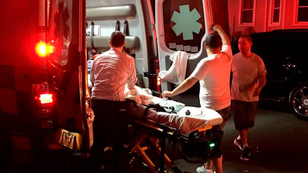 An ambulance paramedic cares for an infant injured in a porch collapse in Hartford, Connecticut.