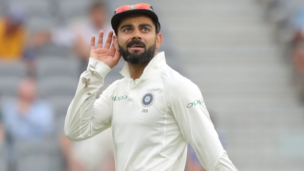 All ears: Virat Kohli gestures to the Perth crowd on day three of the second Test.