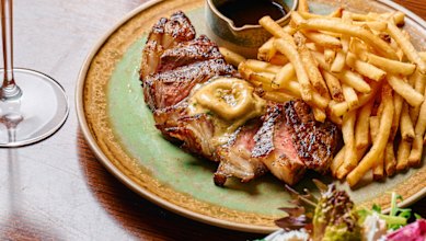 Steak with anchovy-and-confit-garlic butter and bottomless fries at Allegro.