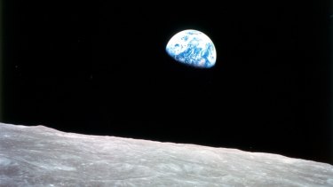 A photo of the Earth rising over the lunar horizon taken in 1968 by the first humans to venture beyond low Earth orbit.