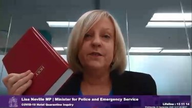 By the book: Police Minister Lisa Neville swears on an upside down bible that she doesn't know who made the decision to use private security guards.