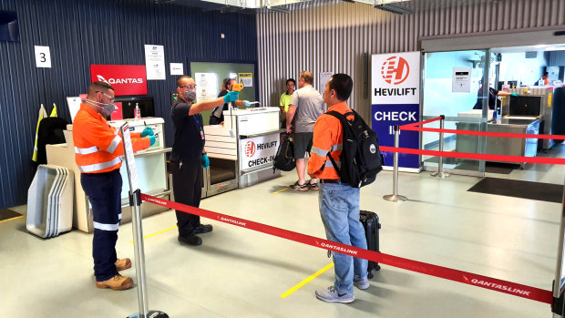 BHP workers receiving mandatory temperature checks at Moranbah airport.