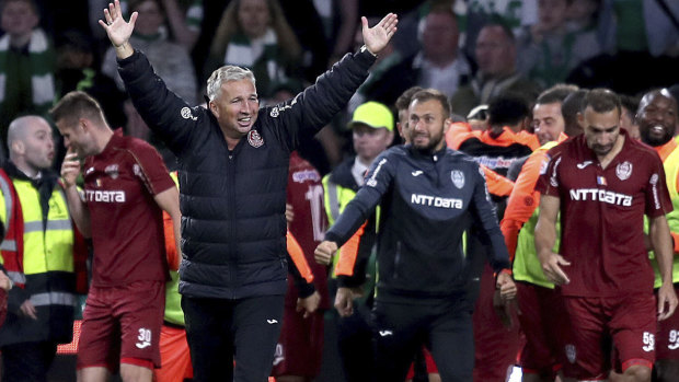 Cluj's manager Dan Petrescu celebrates victory after the final whistle in Glasgow.
