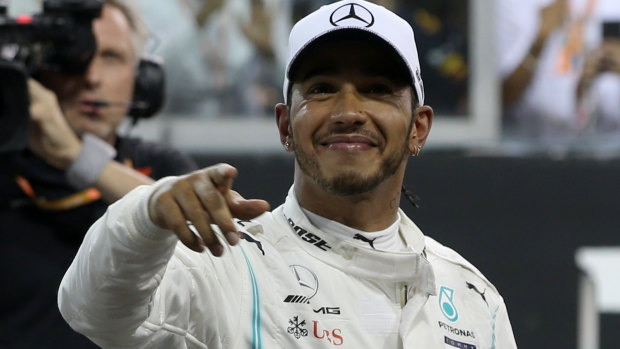 Lewis Hamilton of Great Britain and Mercedes celebrates in parc ferme at the Yas Marina Circuit in Abu Dhabi.