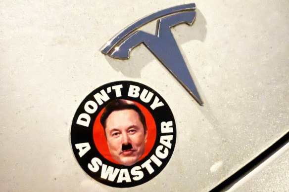 A protest sticker targeting Tesla and Elon Musk.