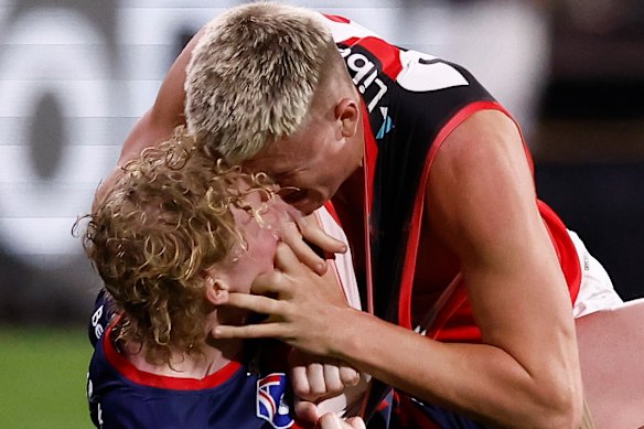 Nate Caddy of the Bombers tries to peer into the soul of Clayton Oliver of the Demons.