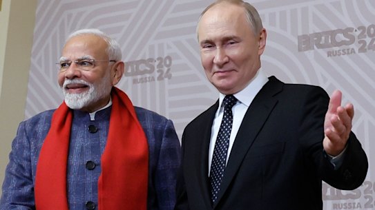 Russian President Vladimir Putin, right, and Indian Prime Minister Narendra Modi shake hands during the welcoming ceremony prior to an informal dinner on the sidelines of BRICS Summit at Kazan City Hall in Kazan, Russia.