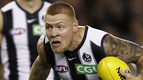 ELBOURNE, AUSTRALIA - MAY 08: Jordan De Goey of the Magpies is tackled by Connor Menadue of the Kangaroos during the 2021 AFL Round 08 match between the North 