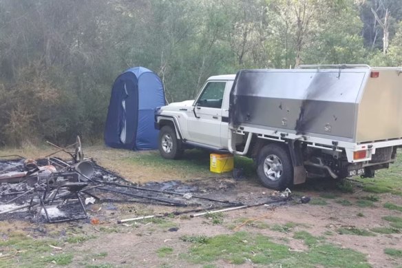 Russell Hill’s Toyota Landcruiser and the burnt campsite at Bucks Camp.