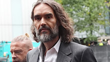 One of Russell Brand’s six accusers told a London court the comedian turned into a “wild-eyed maniac” when he tried to drag her into a toilet cubicle at her workplace.