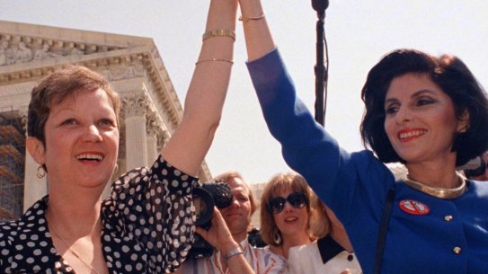 Norma McCorvey, Jane Roe in the 1973 court case, (left) and her attorney Gloria Allred hold hands outside the Supreme Court in Washington in 1989.