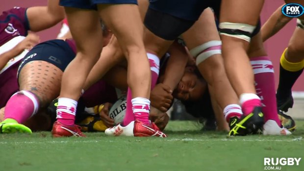 Incriminating shot: Queensland hooker and Wallaroos captain Liz Patu on the replay appearing to bite opponent Rebecca Clough in their Super W clash on Sunday