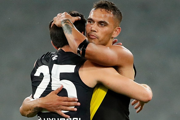 Richmond's Sydney Stack and Carlton's Zac Fisher hug after the game.
