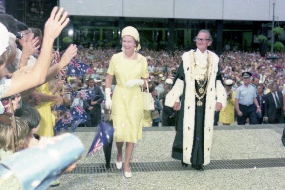 Queen Elizabeth meets crowds of children in the Queen Street Mall in 1982. Here she is accompanied by then lord mayor Frank Sleeman.