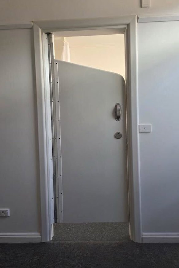 A clinical en suite door from the Swanston Centre in Geelong, which cannot be locked but is all that separates patients in the acute psychiatric ward.